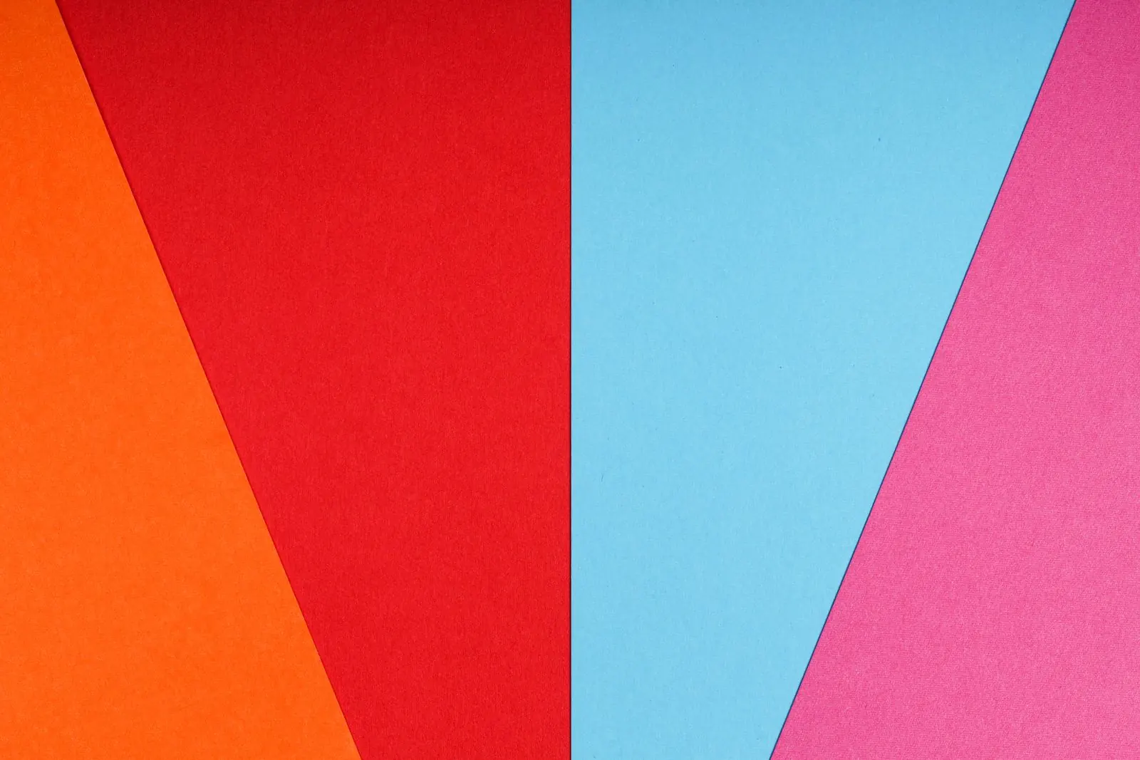 Red, cyan, yellow and magenta paper panels meet in a bold geometric composition.